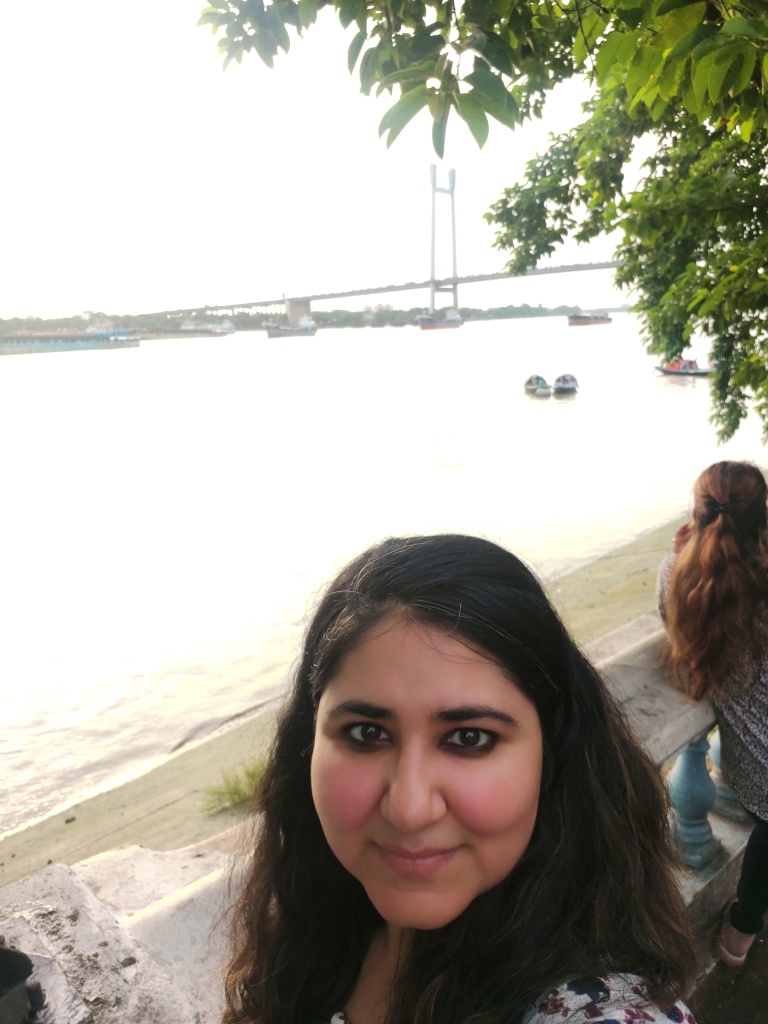 Indian woman's selfie in front of the River Ganges at Prinsep Ghat, Kolkata, West Bengal, India