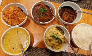 Six bowls containing Bengali dishes