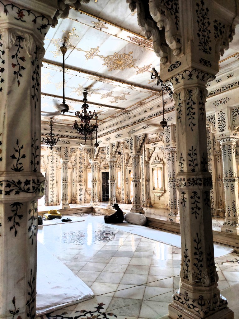 An Indian singer practices along with his harmonium inside a cenotaph.