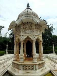 A marble pavilion erected within a water body and with a statue of an Indian politician built inside it.