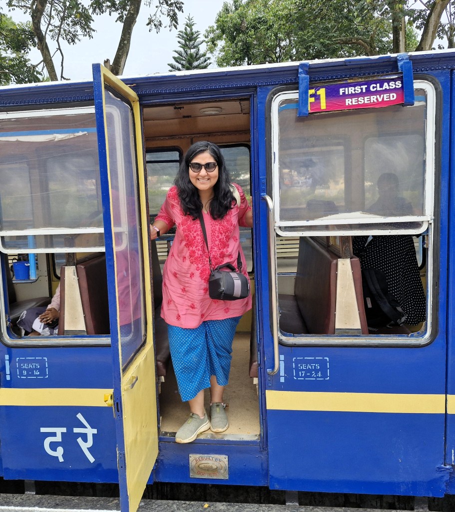 Standing at the door of the First Class coach of the Nilgiri Mountain Railway at the Coonoor Station
